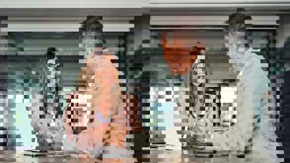 Woman Talking to Elderly Couple About Using Broker to Buy Medical Health Insurance