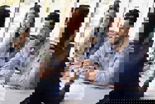 Travelling Man with Expat Health Insurance Sitting on Rock Abroad